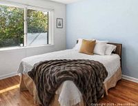 Bedroom view showing assembled queen bed with frame, headboard, box spring