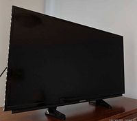 Front view of Sharp 30-inch smart HDTV on dual-leg stand