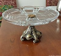 Full view of crystal cake stand on ornate silver base