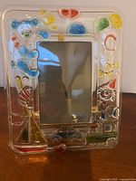 Front view of clear 4x6 picture frame with colourful baby motifs