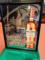 Front view of full Bacardi Gold advertising mirror in frame showing slogan and bottle image
