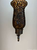 Front view of single mosaic glass sconce showing bronze mount and shade