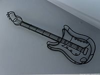Full view of black metal wire guitar wall art