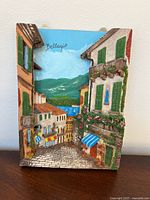 Front view of painted resin Bellagio street scene wall plaque