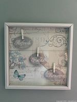 front view of framed wall sign showing plaques and design