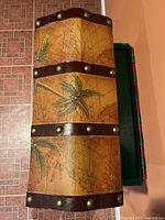 Top view showing palm tree graphics, map print, and studded bands