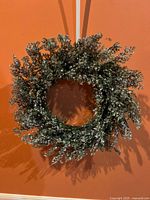 Front view of entire glittered evergreen wreath