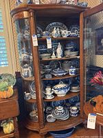 Cabinet view showing entire assortment of blue and white china and blue goblets