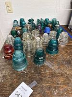 Grouped glass insulators showing color and size variety