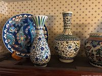 Group view: charger, two vases, bottle vase, partial jar