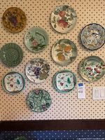 All eleven relief plates mounted on wall