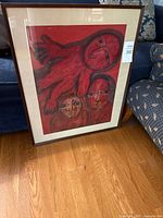 Full view of framed abstract artwork leaning against sofa