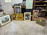 Group shot of all seven framed artworks standing on floor