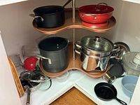 Overview of all cookware items on two-tier lazy-Susan shelf