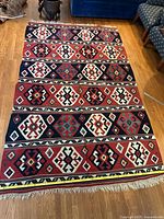 Full view of rug showing pattern, size reference tape measure