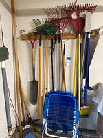 Overall view of rakes, shovels, brooms and chairs