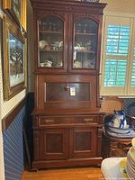 Full view tall wood secretary desk with upper glass cabinet and lower storage