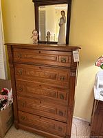 Full view of dresser with mirror, figurine and plush toy