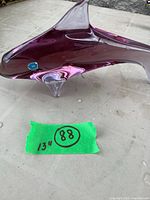 Left side view of amethyst glass shark showing body shape and foil label