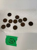 Top view of 12 bronze Canadian Large Cent coins on paper towel