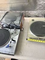 Left silver deck and right beige deck on table