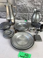 Group shot of entire pewter lot on tabletop