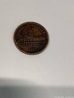 Token obverse showing SEMI-CENTENNIAL legend, building vignette and 1884 date