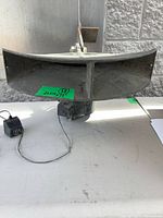 Front view of cast-metal horn speaker with bracket and adapter visible