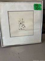 Full view of framed print showing metal frame, mat, and image