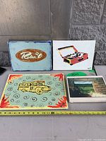 All four canvases side by side with measuring tape for scale