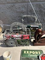 wire radios, wooden figure, tin, cup visible