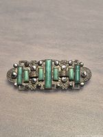 Front view of malachite brooch showing stone setting and bead detail