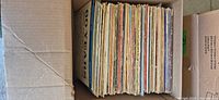 Top view of cardboard box with roughly 50 vertically packed 12" LPs