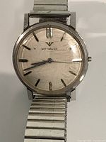 Front view of Wittnauer watch showing dial, case, bracelet, crystal scratches