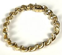 Full view of curved link yellow gold bracelet