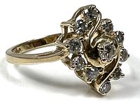 Side view of yellow gold ring showing diamond cluster and swirl design