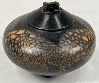Front view of covered jar showing glaze pattern and overall form