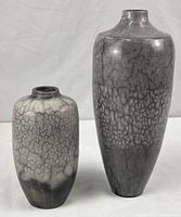 Both pottery vases side by side showing size difference and crackle glaze