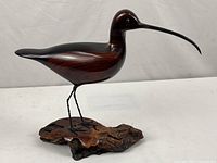 Profile view of carved shorebird on burl base