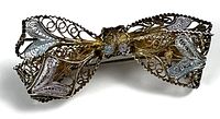front view showing filigree bow design and gold plating
