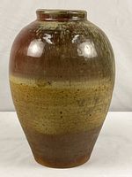 Full front view of glazed ceramic vase showing color gradation
