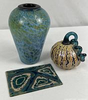 Lot overview showing vase, pumpkin, fused panel