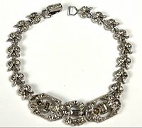 Full view of bracelet laid flat showing entire design and clasp