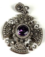 Front view showing filigree cross design and purple stone