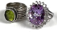 Both sterling rings side by side showing green and purple glass stones
