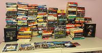 Overall view of entire lot showing paperback stacks, hardcovers and travel guides