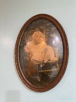 Full view of oval framed baby photograph