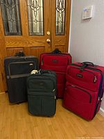 Four suitcases grouped together showing sizes and colors