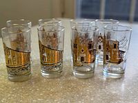 All eight tumblers grouped showing front and back designs
