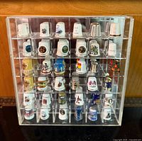 front view of acrylic case filled with thimbles